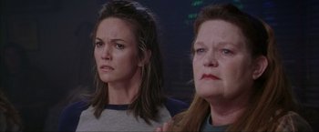Movie still from “The Perfect Storm” (2000), directed by Wolfgang Petersen – Two women looking at each other in front of a building; Close Up shot, Low angle