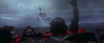 Movie still from “The Perfect Storm” (2000), directed by Wolfgang Petersen – A boat in the ocean with a person in the water; Wide shot, High angle