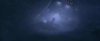 Movie still from “The Perfect Storm” (2000), directed by Wolfgang Petersen – A view from above of a dark room with lights on; Extreme Wide shot, Overhead angle