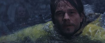 Movie still from “The Perfect Storm” (2000), directed by Wolfgang Petersen – A person swimming in a body of water; Close Up shot, Over the shoulder angle