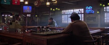 Movie still from “The Perfect Storm” (2000), directed by Wolfgang Petersen – A man sitting at a table in front of a chess board; Wide shot, High angle