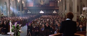 Movie still from “The Perfect Storm” (2000), directed by Wolfgang Petersen – A large group of people sitting in a large church; Wide shot, High angle