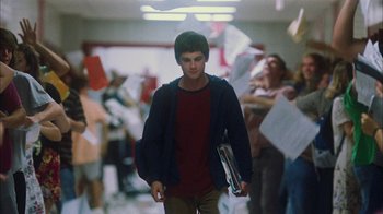 Movie still from “The Perks of Being a Wallflower” (2012), directed by Stephen Chbosky – A young man is walking through a crowd of people; Wide shot, Low angle