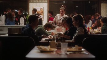 Movie still from “The Perks of Being a Wallflower” (2012), directed by Stephen Chbosky – A group of people sitting at a restaurant table; Medium shot, Over the shoulder angle