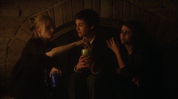 Movie still from “The Perks of Being a Wallflower” (2012), directed by Stephen Chbosky – A man sitting on a chair next to two other people; Medium shot, Low angle
