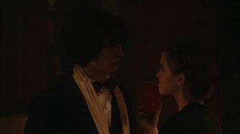 Movie still from “The Perks of Being a Wallflower” (2012), directed by Stephen Chbosky – A man and a woman holding a drink in a dark room; Medium shot, Over the shoulder angle