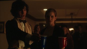 Movie still from “The Perks of Being a Wallflower” (2012), directed by Stephen Chbosky – A man and a woman are holding drinks; Medium shot, Over the shoulder angle