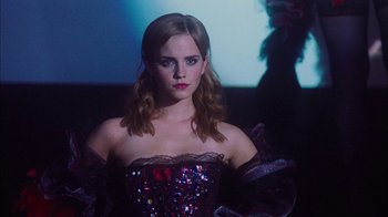 Movie still from “The Perks of Being a Wallflower” (2012), directed by Stephen Chbosky – A woman in a strapless dress is posing for a picture; Medium shot, Low angle
