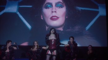 Movie still from “The Perks of Being a Wallflower” (2012), directed by Stephen Chbosky – A group of people standing in front of a screen; Medium shot, Low angle