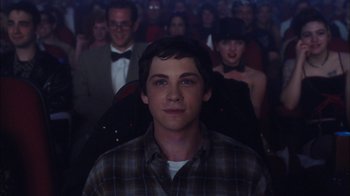 Movie still from “The Perks of Being a Wallflower” (2012), directed by Stephen Chbosky – A man in a crowd of people in a room; Close Up shot, Over the shoulder angle