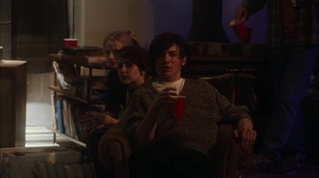 Movie still from “The Perks of Being a Wallflower” (2012), directed by Stephen Chbosky – A man and a woman sitting in a chair drinking a beverage; Medium shot, Over the shoulder angle