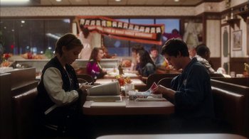 Movie still from “The Perks of Being a Wallflower” (2012), directed by Stephen Chbosky – A couple of people sitting at a table in a restaurant; Medium shot, High angle