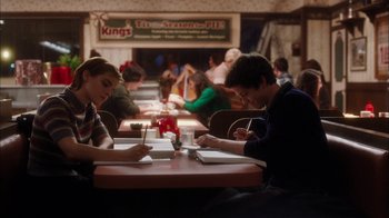 Movie still from “The Perks of Being a Wallflower” (2012), directed by Stephen Chbosky – A couple of people sitting at a table in a restaurant; Medium shot, Over the shoulder angle