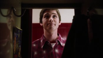 Movie still from “The Perks of Being a Wallflower” (2012), directed by Stephen Chbosky – A young man looking into a mirror in a room with red walls; Close Up shot, Low angle