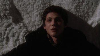 Movie still from “The Perks of Being a Wallflower” (2012), directed by Stephen Chbosky – A man laying on the ground in the dark; Close Up shot, Overhead angle