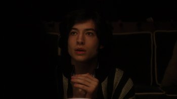 Movie still from “The Perks of Being a Wallflower” (2012), directed by Stephen Chbosky – A man with dark hair is sitting in a dark room; Close Up shot, Over the shoulder angle