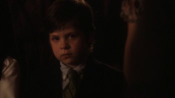 Movie still from “The Perks of Being a Wallflower” (2012), directed by Stephen Chbosky – A boy in a suit and tie in a dark room; Close Up shot, Over the shoulder angle