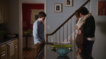 Movie still from “The Perks of Being a Wallflower” (2012), directed by Stephen Chbosky – A man standing in front of a bowl on a table; Wide shot, Over the shoulder angle