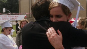 Movie still from “The Perks of Being a Wallflower” (2012), directed by Stephen Chbosky – A man and a woman hugging each other in front of a group of people; Close Up shot, Over the shoulder angle