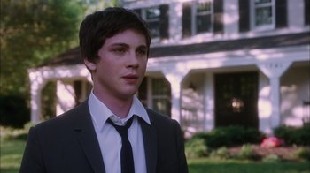 Movie still from “The Perks of Being a Wallflower” (2012), directed by Stephen Chbosky – A man in a suit and tie standing in front of a house; Close Up shot, Over the shoulder angle