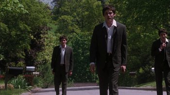 Movie still from “The Perks of Being a Wallflower” (2012), directed by Stephen Chbosky – Two men in suits walking down a street; Wide shot, Low angle