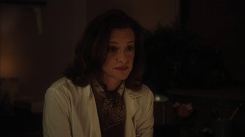Movie still from “The Perks of Being a Wallflower” (2012), directed by Stephen Chbosky – A woman wearing a white lab coat sitting in front of a wall; Close Up shot, Over the shoulder angle