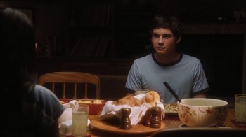 Movie still from “The Perks of Being a Wallflower” (2012), directed by Stephen Chbosky – A man sitting at a table with food on it; Medium shot, Over the shoulder angle