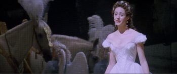 Movie still from “The Phantom of the Opera” (2004), directed by Joel Schumacher – A woman in a white dress standing in front of a flock of birds; Medium shot, Over the shoulder angle
