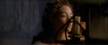 Movie still from “The Phantom of the Opera” (2004), directed by Joel Schumacher – A woman with long curly brown hair wearing a white dress; Close Up shot, Over the shoulder angle
