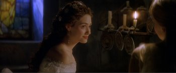 Movie still from “The Phantom of the Opera” (2004), directed by Joel Schumacher – A woman in a white dress with a tiara on her head; Close Up shot, Over the shoulder angle