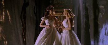 Movie still from “The Phantom of the Opera” (2004), directed by Joel Schumacher – Two young women in white dresses talking to each other; Medium shot, Low angle