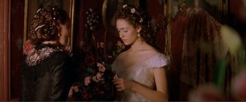 Movie still from “The Phantom of the Opera” (2004), directed by Joel Schumacher – A woman in a white dress holding a flower; Close Up shot, Over the shoulder angle