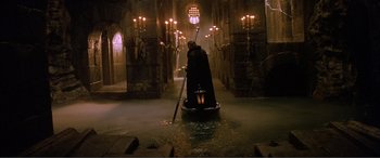 Movie still from “The Phantom of the Opera” (2004), directed by Joel Schumacher – A person in a boat in a dark setting; Extreme Wide shot, High angle