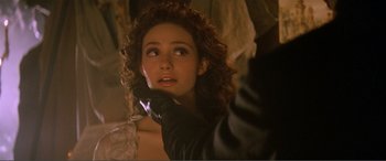 Movie still from “The Phantom of the Opera” (2004), directed by Joel Schumacher – A person wearing a glove; Close Up shot, Over the shoulder angle