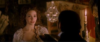 Movie still from “The Phantom of the Opera” (2004), directed by Joel Schumacher – A woman in a white dress and a man in a black suit; Close Up shot, Over the shoulder angle