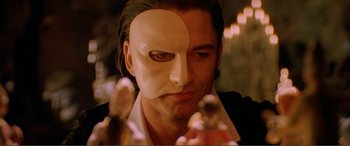 Movie still from “The Phantom of the Opera” (2004), directed by Joel Schumacher – A person wearing a mask; Close Up shot, Low angle