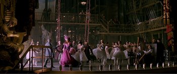 Movie still from “The Phantom of the Opera” (2004), directed by Joel Schumacher – A group of people are dancing on a stage; Extreme Wide shot, High angle
