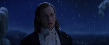 Movie still from “The Phantom of the Opera” (2004), directed by Joel Schumacher – A man with long hair wearing a white shirt and a black jacket; Close Up shot, Low angle