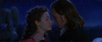 Movie still from “The Phantom of the Opera” (2004), directed by Joel Schumacher – A man and a woman kissing each other in the dark; Close Up shot, Over the shoulder angle