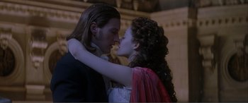 Movie still from “The Phantom of the Opera” (2004), directed by Joel Schumacher – A man and a woman are kissing each other; Close Up shot, Low angle