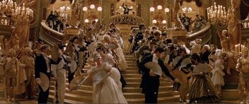 Movie still from “The Phantom of the Opera” (2004), directed by Joel Schumacher – A group of people dressed up in fancy clothing; Extreme Wide shot, High angle