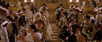 Movie still from “The Phantom of the Opera” (2004), directed by Joel Schumacher – A group of people dressed up in fancy clothing; Wide shot, High angle