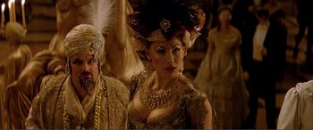 Movie still from “The Phantom of the Opera” (2004), directed by Joel Schumacher – A woman in a gold dress and a feather headdress; Close Up shot, Over the shoulder angle