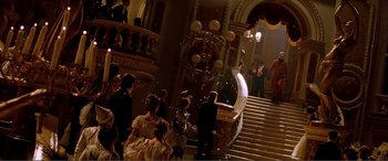 Movie still from “The Phantom of the Opera” (2004), directed by Joel Schumacher – A group of people standing on a set of stairs; Extreme Wide shot, Low angle