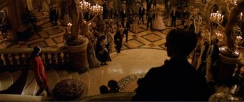 Movie still from “The Phantom of the Opera” (2004), directed by Joel Schumacher – A group of people sitting on the floor of a room; Extreme Wide shot, High angle