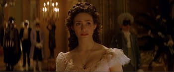 Movie still from “The Phantom of the Opera” (2004), directed by Joel Schumacher – A woman in a white dress with a necklace; Close Up shot, Over the shoulder angle