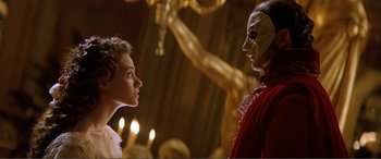 Movie still from “The Phantom of the Opera” (2004), directed by Joel Schumacher – A man and a woman face to face in a room; Close Up shot, Low angle