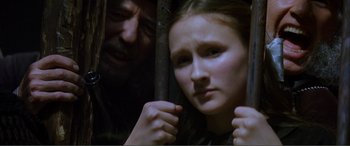 Movie still from “The Phantom of the Opera” (2004), directed by Joel Schumacher – A man and a woman looking at each other through a fence; Close Up shot, Over the shoulder angle