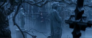 Movie still from “The Phantom of the Opera” (2004), directed by Joel Schumacher – A woman dressed as snow white in a snowy forest; Wide shot, High angle