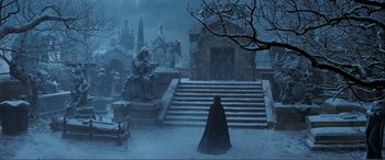 Movie still from “The Phantom of the Opera” (2004), directed by Joel Schumacher – A man in a black cloak stands in front of a castle; Extreme Wide shot, High angle